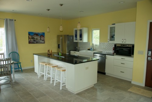 Cook top in island. Refrigerator, country sink, dish washer, microwave, kitchen appliances